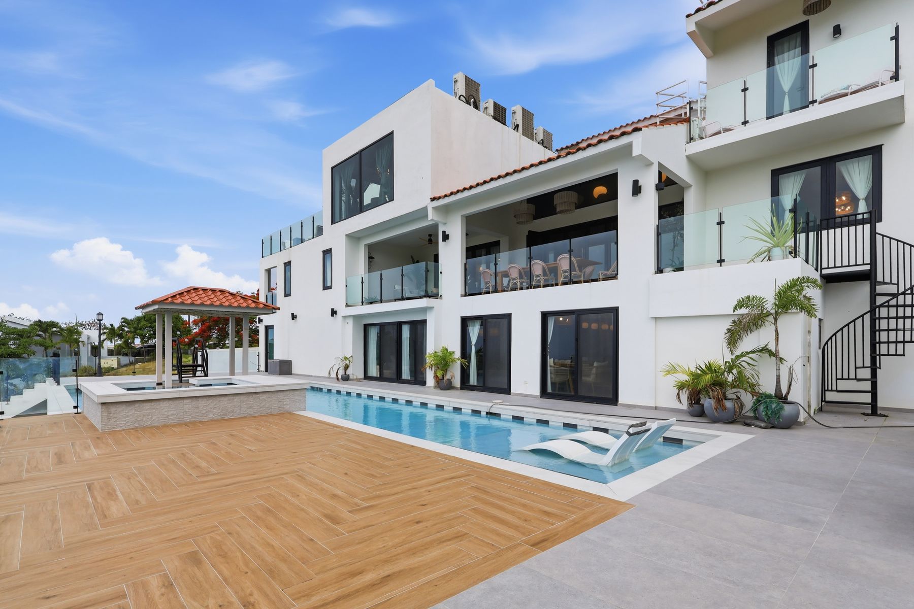 Elevated view of a modern Puerto Rico home with pool and terrace — drone photography by Diego Bou
