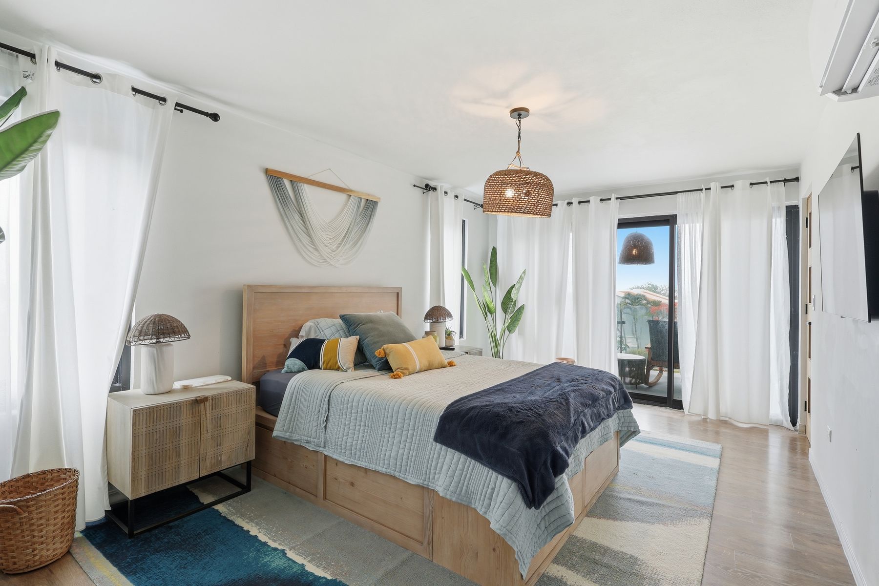 Cozy master suite with pendant lighting and layered textures — Bou Photography