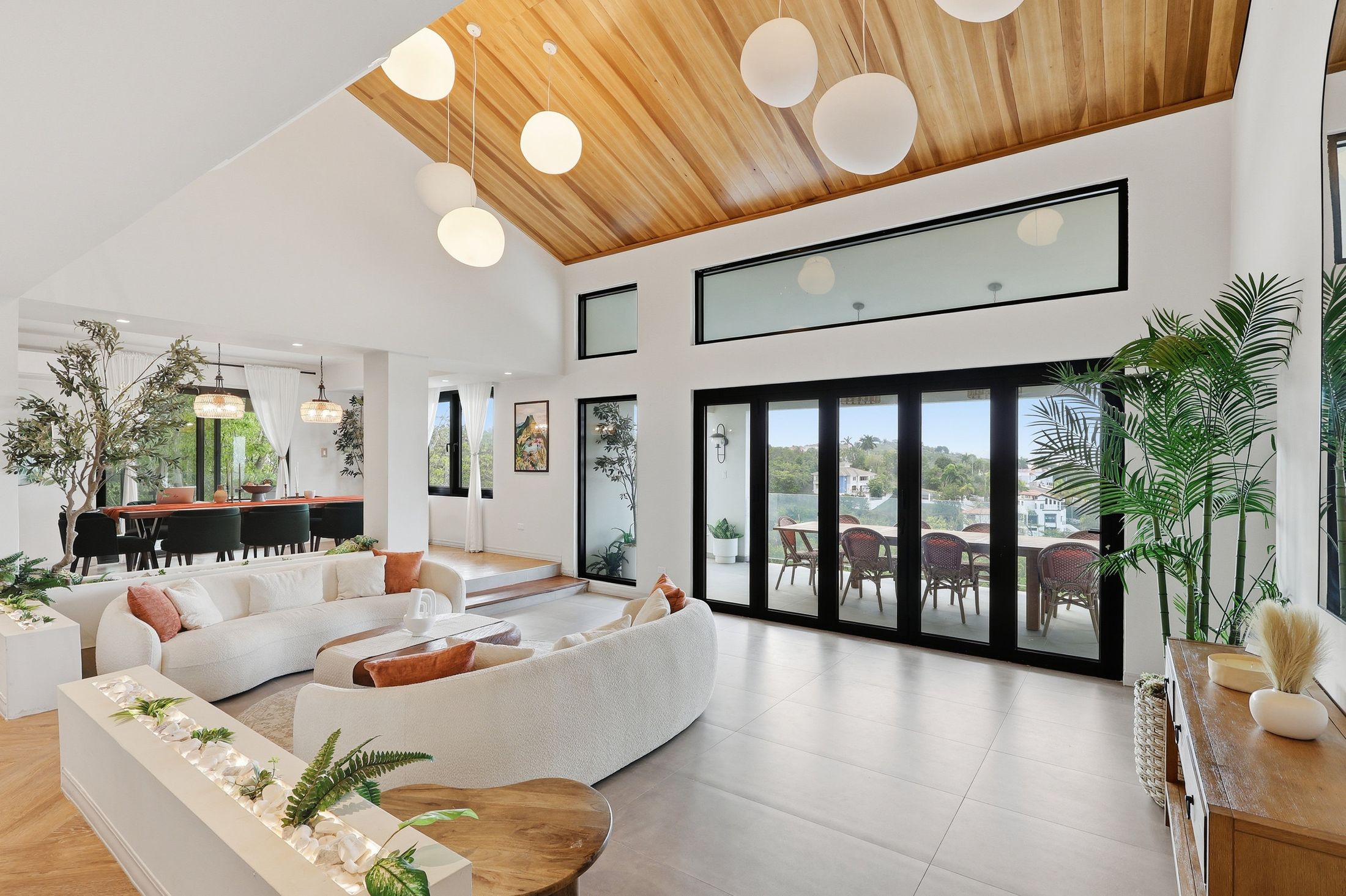 Open-plan living room with wood ceiling and terrace view — photographed by Diego Bou