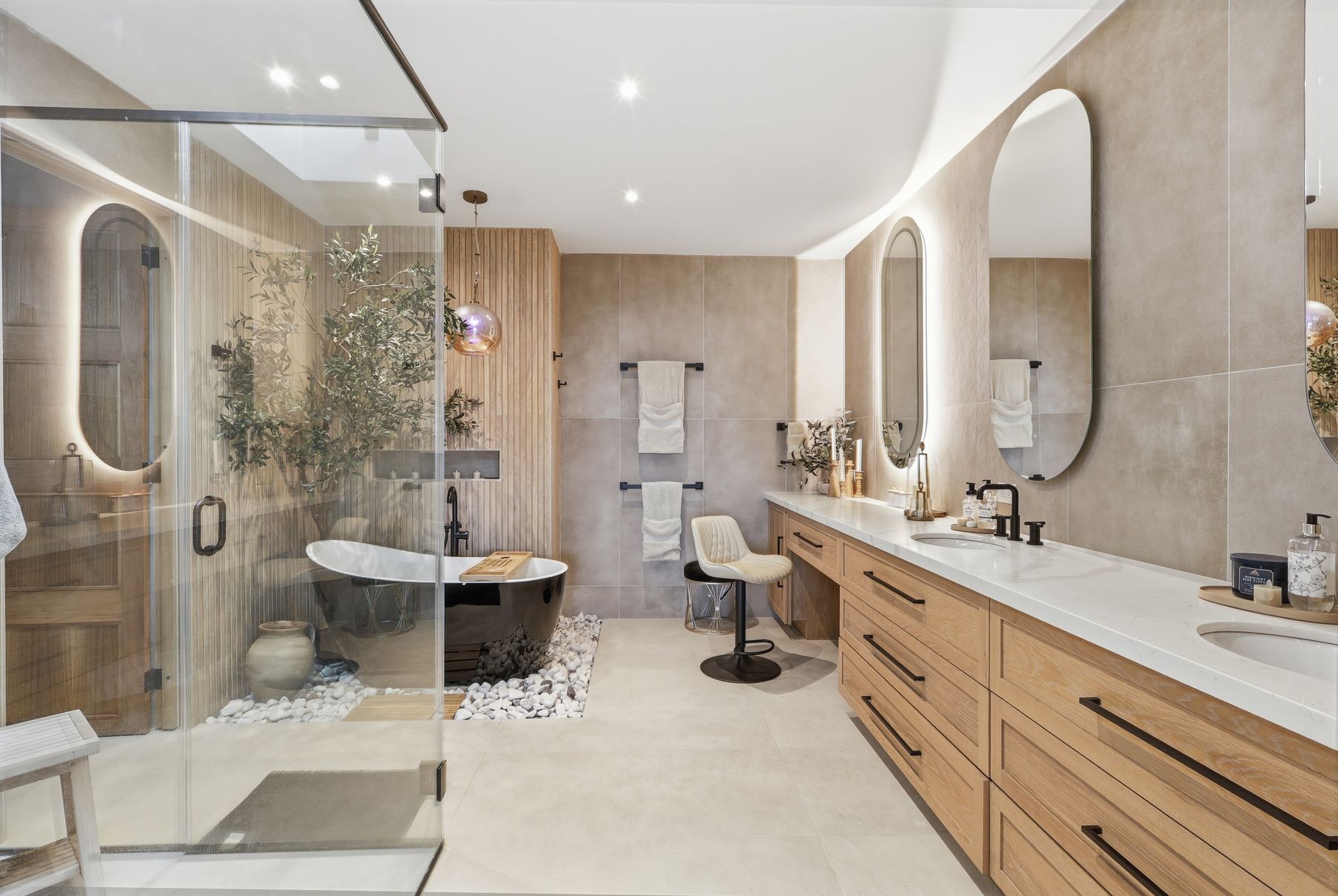Luxury master bathroom with double vanity and freestanding tub — real estate photography by Diego Bou