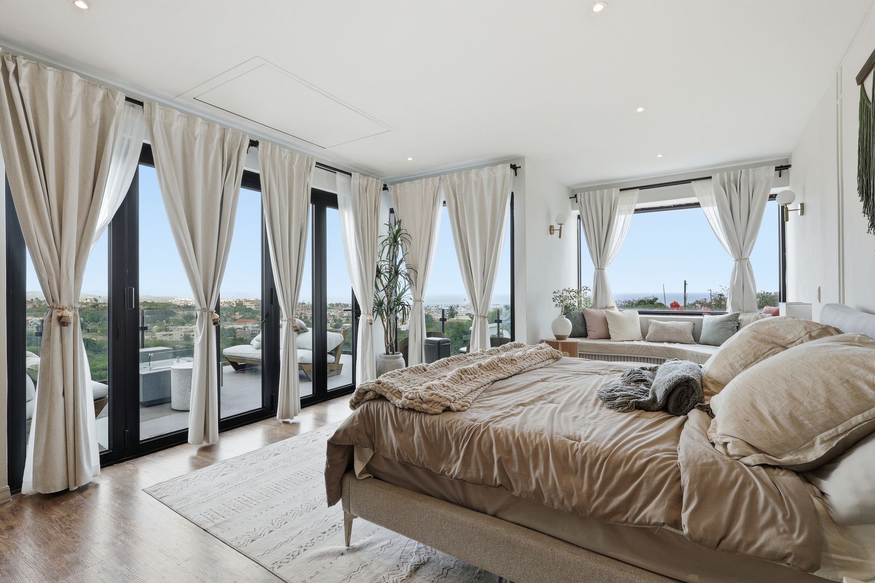 Bright modern master bedroom with floor-to-ceiling windows — Bou Photography